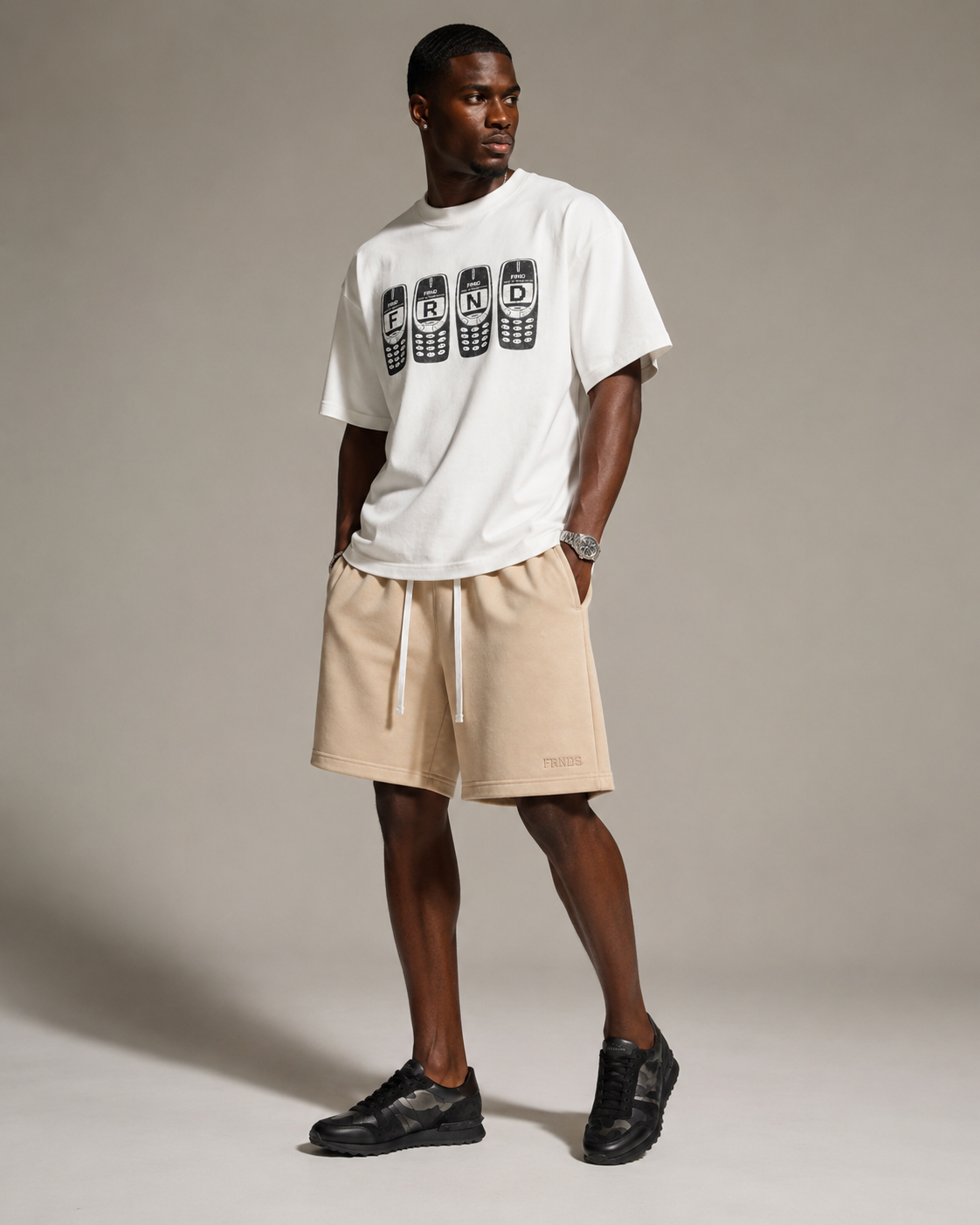 Model wearing cream FRNDS Tonal Shorts with Brick Phone tee