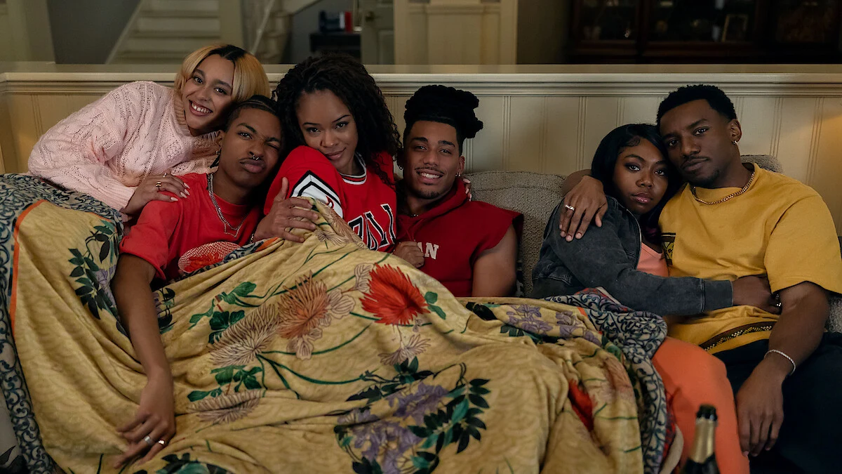 The new A Different World cast gathered around a couch